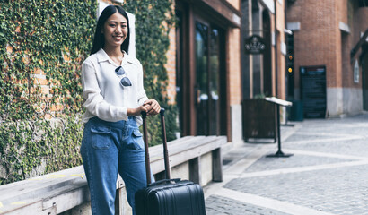 Asian woman carrying a big black bag to travel during the vacation of the year, Trolley bag, Long weekend travel, Love the trip, Tourism festival concept.