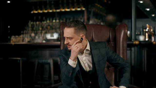 successful bearded businessman in a business suit with a cigar in his hand coughs from cigarette smoke. 4K footage