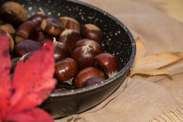 chestnuts in the pan to be roasted in autumn