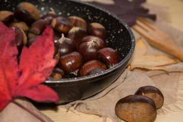 chestnuts in the pan to be roasted in autumn