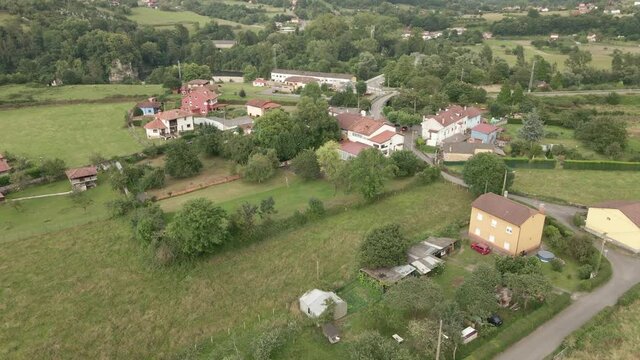 Flying Over The Houses And Buildings Near The Parque Infantil - Playground At Caserio Rienda, Oviedo Near The Nalon River In Asturias, Spain. - aerial drone shot