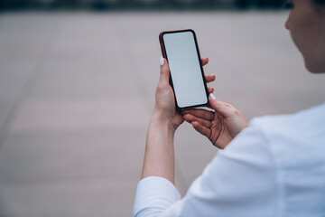 Crop woman showing empty screen on cellphone
