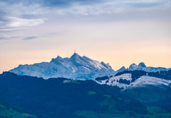 Obraz na płótnie Canvas Sunrise view of the snow covered Santis peak, the highest mountain in the Alpstein massif of northeastern Switzerland