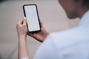 Crop woman chatting on cellphone
