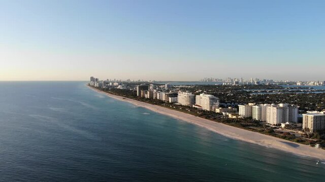 Stunning surfside Florida coastline at sunset with hotels and pristine white sand beaches