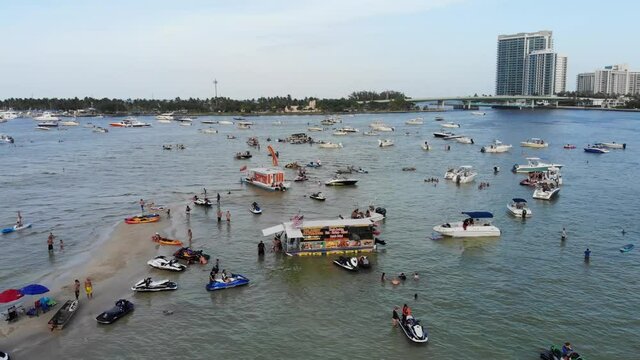 Boat party meet up with hundreds of people at mass gathering of boats in Haulover Sandbar