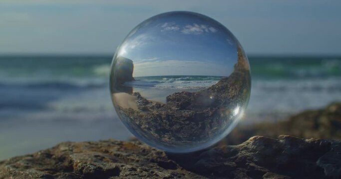 Dreamy Abstract View of Ocean looking through Glass Lens Sphere Ball, Cornwall, UK, close up