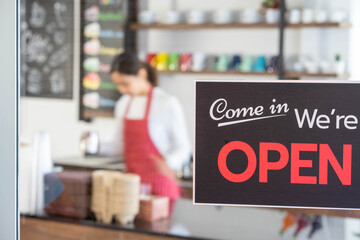 Barista opening coffee shop cafe with bean grinder espresso machine. food and drink concpet