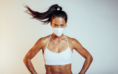 Muscular sports woman with face mask
