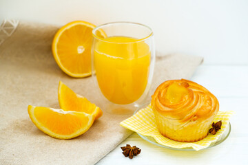 Orange cake and orange juice on white wooden background