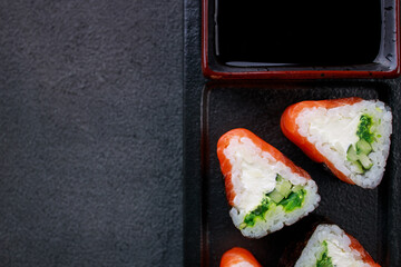 Seafood delicatessen salmon sushi rolls on plate