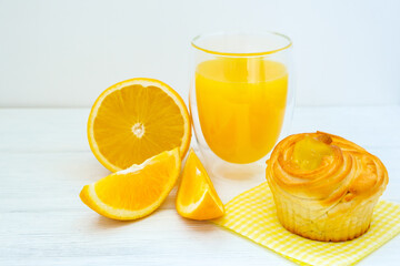 Orange cake and orange juice on white wooden background
