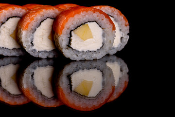 Fresh delicious beautiful sushi rolls on a dark background