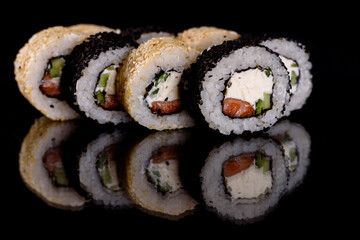 Fresh delicious beautiful sushi rolls on a dark background