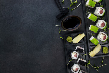 Obraz na płótnie Canvas Seafood delicatessen sushi rolls set on plates.