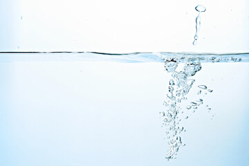 Close up of clean blue water and splash with bubbles of air isolated on white background. Diet,...