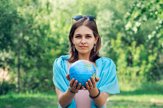 Portrait Of Woman Holding Globe