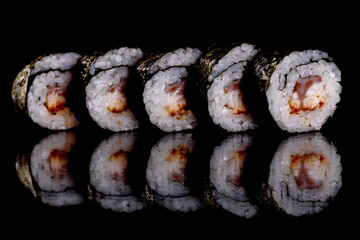 Fresh delicious beautiful sushi rolls on a dark background