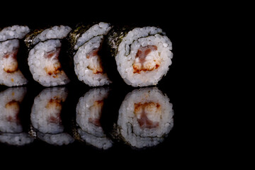Fresh delicious beautiful sushi rolls on a dark background