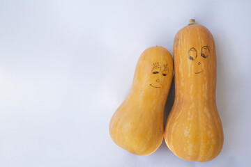 On a white background, two painted pumpkins, a couple in love.
