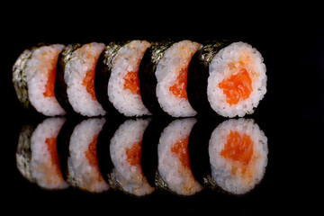 Fresh delicious beautiful sushi rolls on a dark background