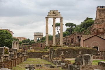 Fototapeta na wymiar Three standing columns from the ruins of the Temple of Castor and Pollux. The Temple of Castor and Pollux is an ancient temple in the Roman Forum, Rome, Italy