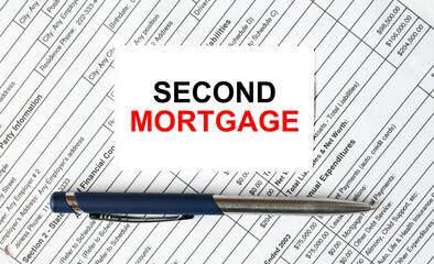 Text Second Mortgage written on a business card lying on financial tables with a blue metal pen
