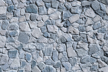 An unusual wall of wild stone blue. Background.