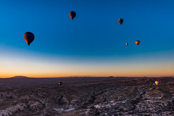 Hot air balloons  at sunrise in  Goreme National Park, Cappadocia, Turkey.