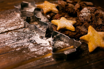 Rustic Christmas wooden background with cookies cutters, fir tree
