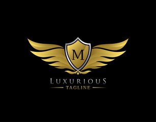 Luxury Wings Logo With M Letter. Elegant Gold Shield badge design for Royalty, Letter Stamp, Boutique,  Hotel, Heraldic, Jewelry, Automotive.