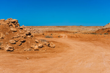 Red dirt road in rocky desert scenery