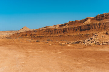 Fototapeta na wymiar Red dirt road in rocky desert scenery
