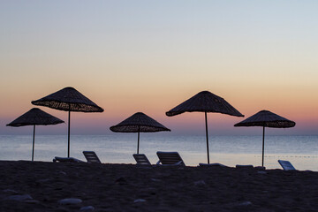 wicker umbrellas at sunrise