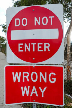 Do Not Enter Wrong Way street sign alert. Road warning post on red color for traffic safety