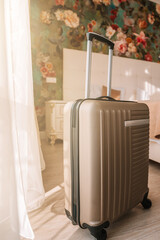 Sevastopol / Crimea - 22 Sep 2020: Travel suitcase stands in a white clean hotel room with light from the window, relaxing time, holiday, weekend and traveling concept.