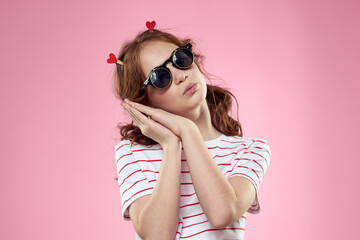 Cute girl sunglasses striped t-shirt lifestyle fun style pink background