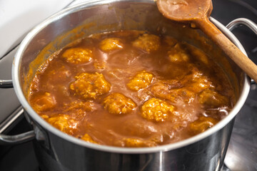 cooking soy vegetarian balls in sauce