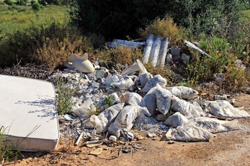 Garbage dump across forest road in the outskirts of Athens in Attica, Greece.