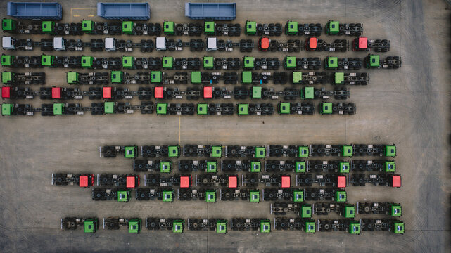 Aerial View Of Trucks Parked In Row On Land