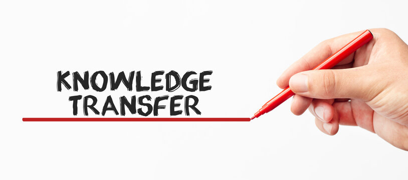 Hand writing KNOWLEDGE TRANSFER with red marker. Isolated on white background. Business, technology, internet concept. Stock Image