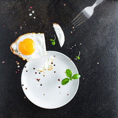 Fototapeta na wymiar fried egg yolk and white, fork for eat omelette fresh dish and ingredients on the table tasty serving size top view copy space for text food background rustic