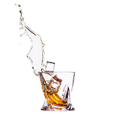 A glass of whiskey with splashes from the ice cube isolated on white. alcohol splashes. whisky or cognac or another type of alcohol.