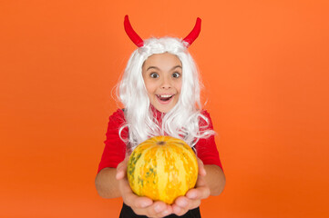 happy halloween party child wearing imp costume and having fun while celebrating autumn traditional...