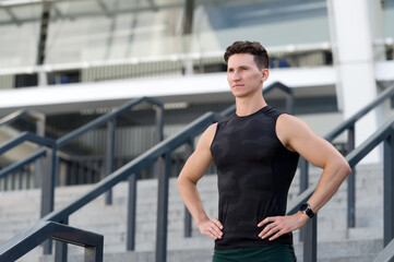 Man muscular shoulders motivated for workout urban background