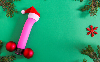Pink dildo and christmas decor

Pink dildo in a Santa Claus hat and Christmas decor with a Christmas tree around the edges on a green background, top view close-up. - obrazy, fototapety, plakaty