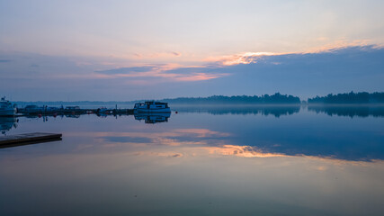 Peaceful sunrise captured in Helsinki, Finland at early morning while the sun was hiding behind the clouds giving out beautiful colours 