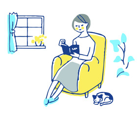 ソファに座って本を読んでいる女性