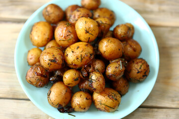 Selective focus. Baked potatoes in their skins. Mini potatoes in a plate. Healthy food.