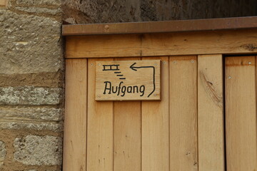 Plaque on a wooden gate, text in German: Stairs